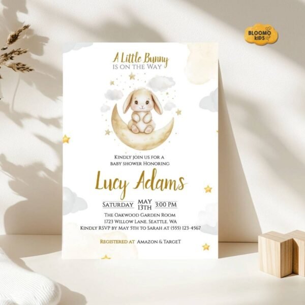 Neutral baby shower invitation with bunny on the moon design in a soft beige setting.