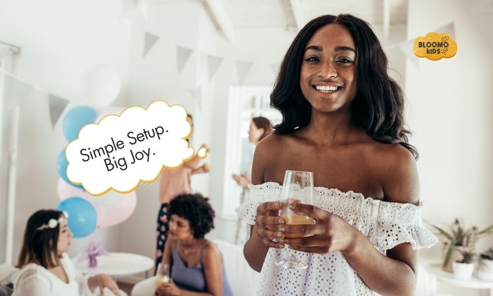 Smiling woman at a baby shower holding a drink in a bright, decorated room.
